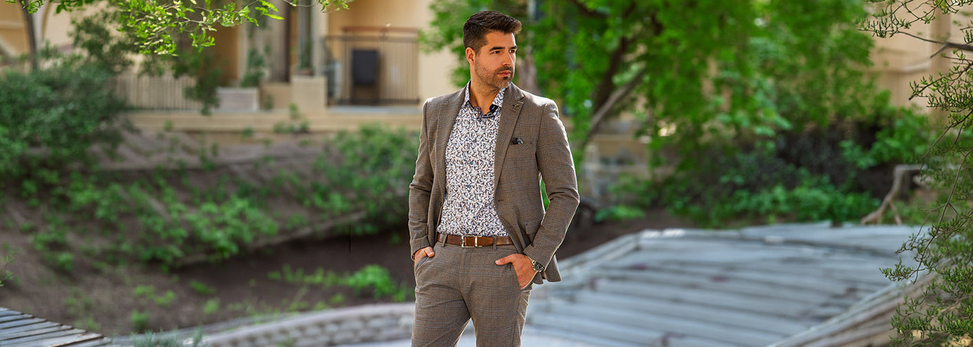 Modèle homme portant une chemise blanche élégante près d'une voiture sportive dans un environnement luxueux. Découvrez les nouveautés Au Noir avec coupes modernes, tissus haut de gamme et style contemporain.