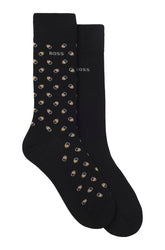 Ensemble de bas mi-mollet noirs, un à motif beige et blanc et un uni avec logo BOSS, vue produit pour homme par HUGO BOSS