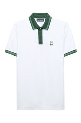 Polo blanc à manches courtes avec col, patte et bordures verts, vue produit pour homme par Psycho Bunny