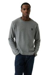Garcia men's gray textured crewneck knit long-sleeve knit sweater on model, front waist-up view with small chest logo patch