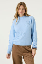 Front model view of women's light blue mock neck knit long-sleeve knit sweater with raised floral embroidery by Garcia