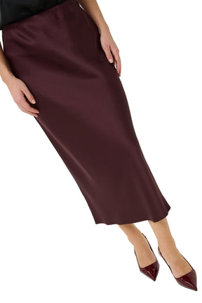 Women's angled close view of the dark burgundy textured midi skirt showing sheen and drape by Kaffe