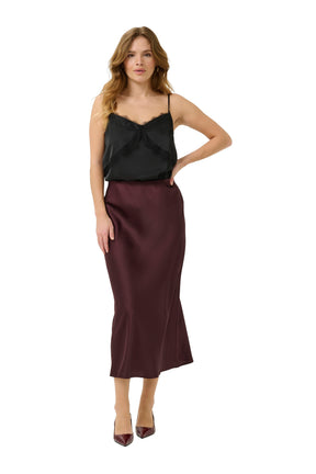Kaffe women's dark burgundy midi skirt styled with a black camisole, front model view