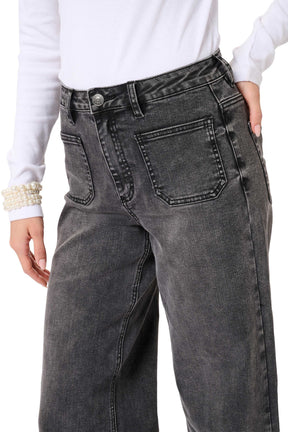 Women's close detail of washed black wide-leg jeans showing button waist, belt loops, and front patch pocket by Kaffe