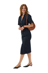 Women's angled front model view of dark indigo denim midi midi short-sleeve dress with button placket, side view by Kaffe
