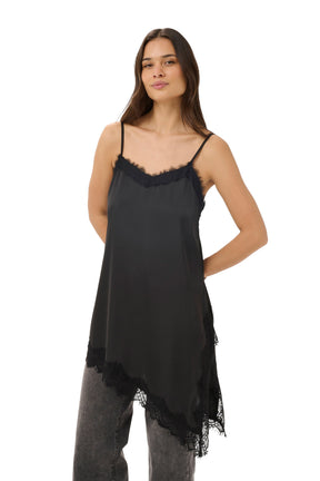 Women's angled front view of black lace-trim camisole sleeveless camisole top with asymmetrical hem over jeans by Kaffe
