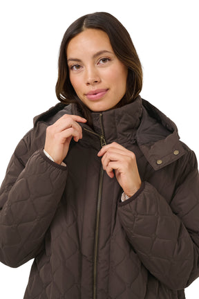 Cream women's collar detail of brown quilted coat with open hood, zipper and snap-tab front