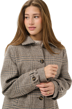 Cream women's close model view of beige plaid jacket with foldover collar, dark buttons, and cuff tab