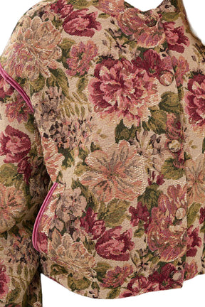 Cream women's beige floral tapestry jacket showing fabric buttons, pink piping, and pocket trim, close-up