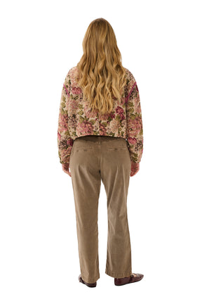 Cream women's cropped beige floral tapestry jacket with dropped shoulders and long sleeves shown from the back