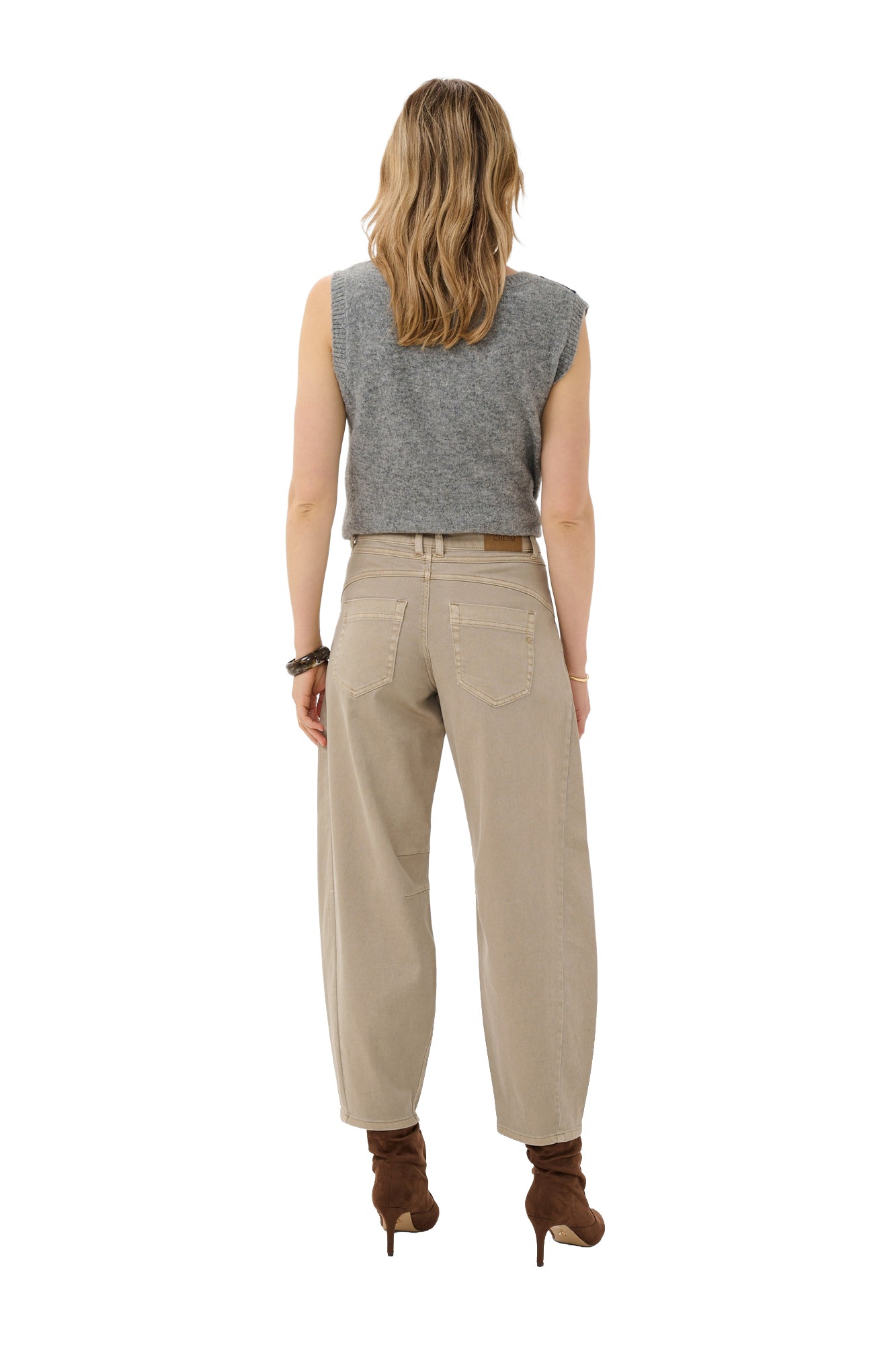 Cream women's beige jeans on model, showing patch pockets, belt loops, and tapered hems, back view