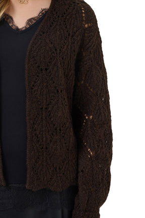 Cream women's dark brown cardigan showing fuzzy openwork knit texture on the sleeve and front, close-up