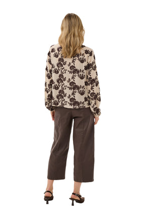 Women's cream long sleeve blouse with dark brown allover floral embroidery shown from the back