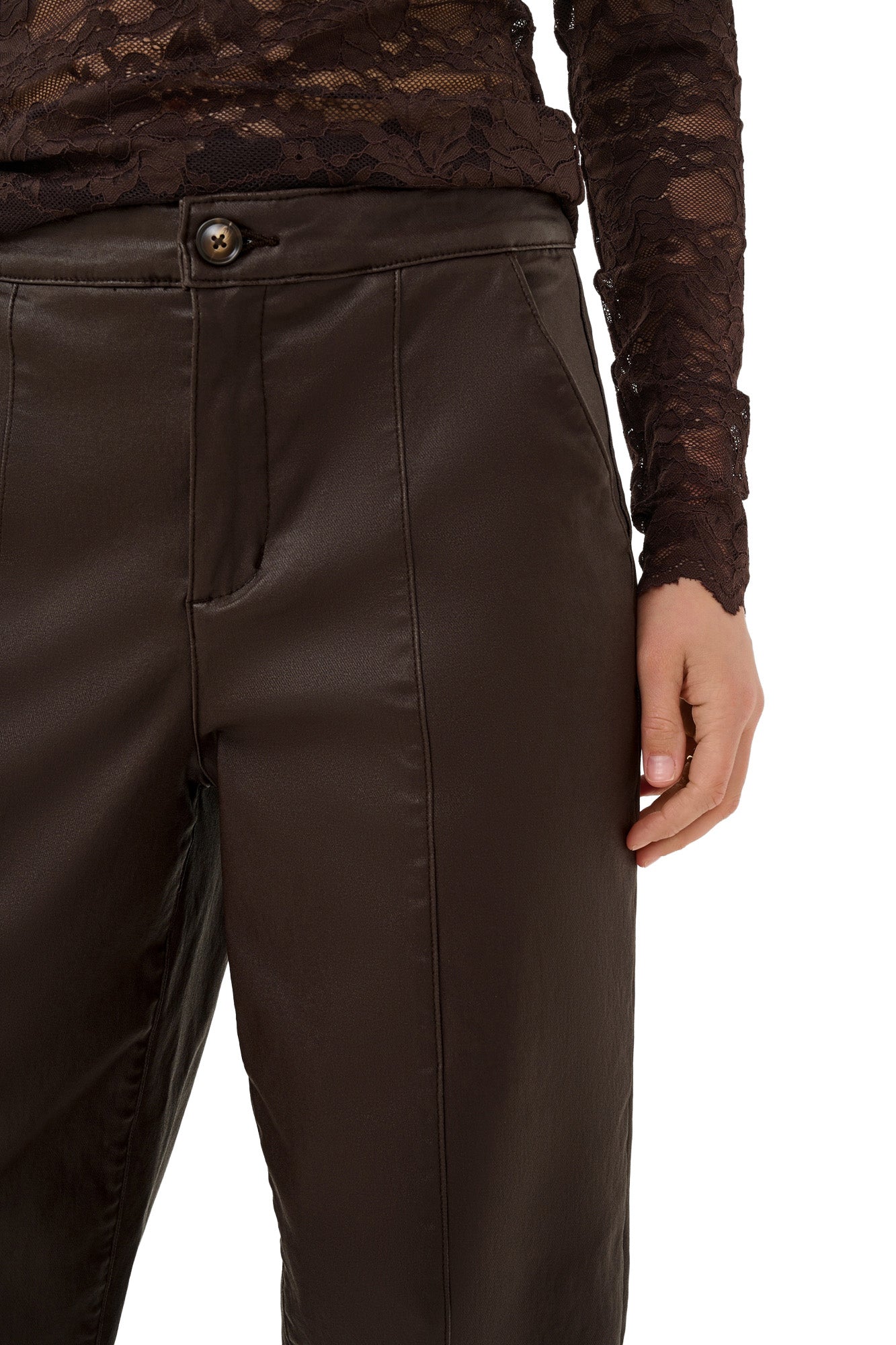Cream women's dark brown faux-leather straight-leg pants waistband, button fly, pocket, and vertical seam, close-up