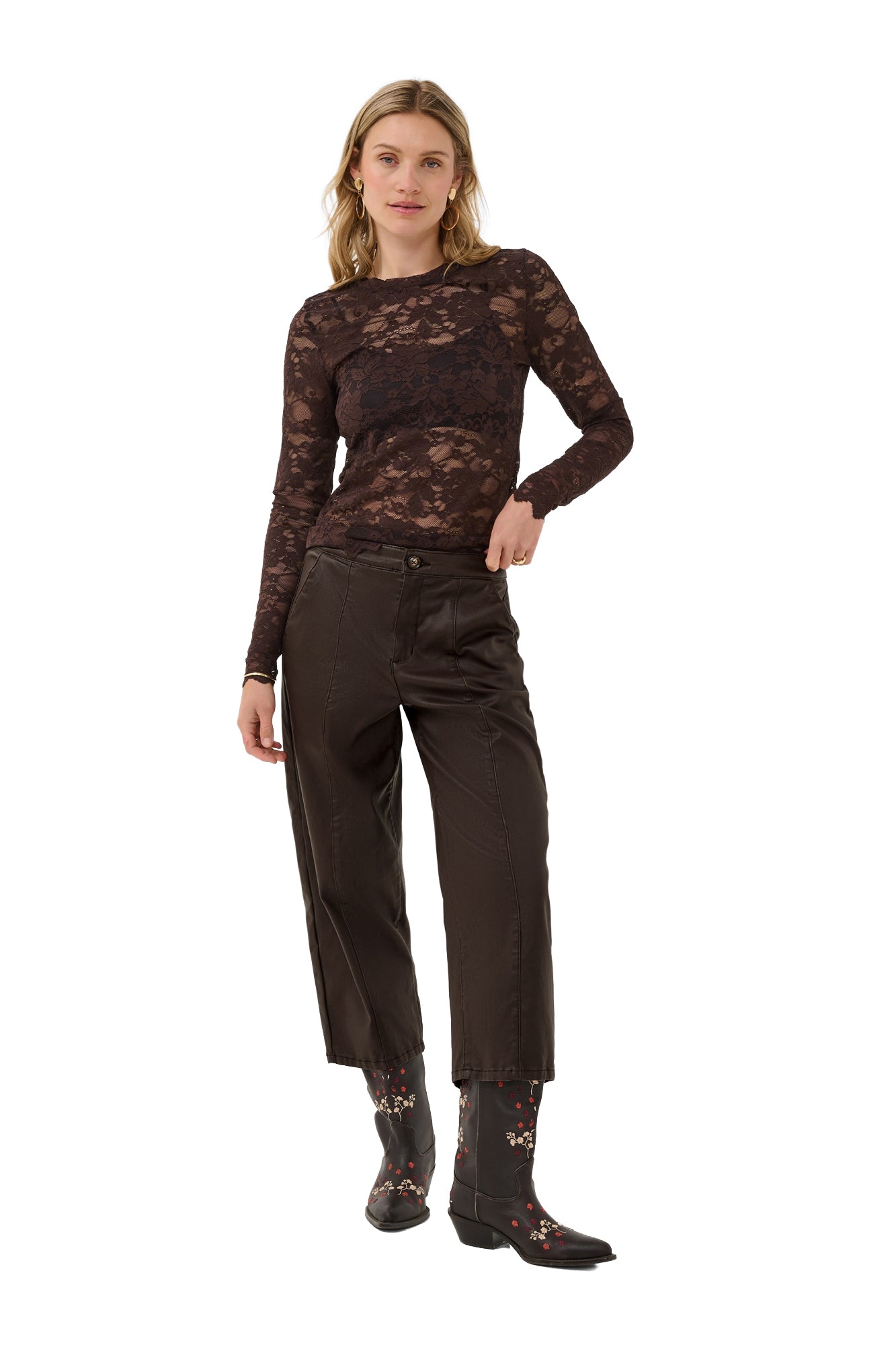 Cream women's dark brown faux-leather straight-leg pants angled front view on model with button waist and seam panels