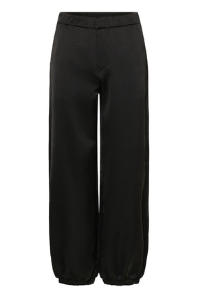 Cream women's black satin-look jogger pants with fly seam and elastic ankle hems, isolated front view