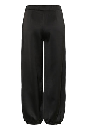 Cream women's black satin-look jogger pants with flat waistband and gathered hems shown from the back