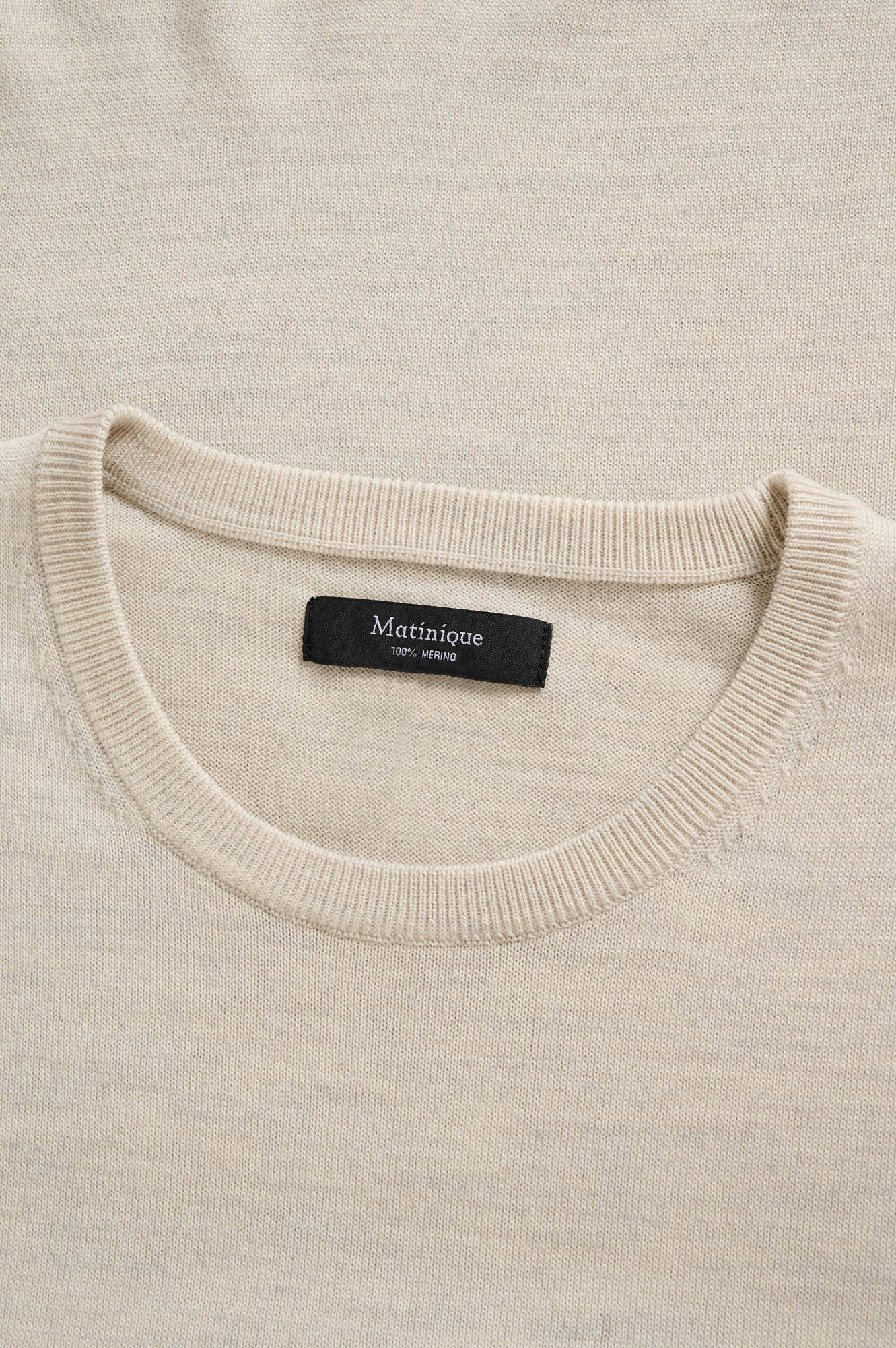 Matinique men's collar detail of the light beige knit long-sleeve knit sweater with ribbed crewneck and black neck label