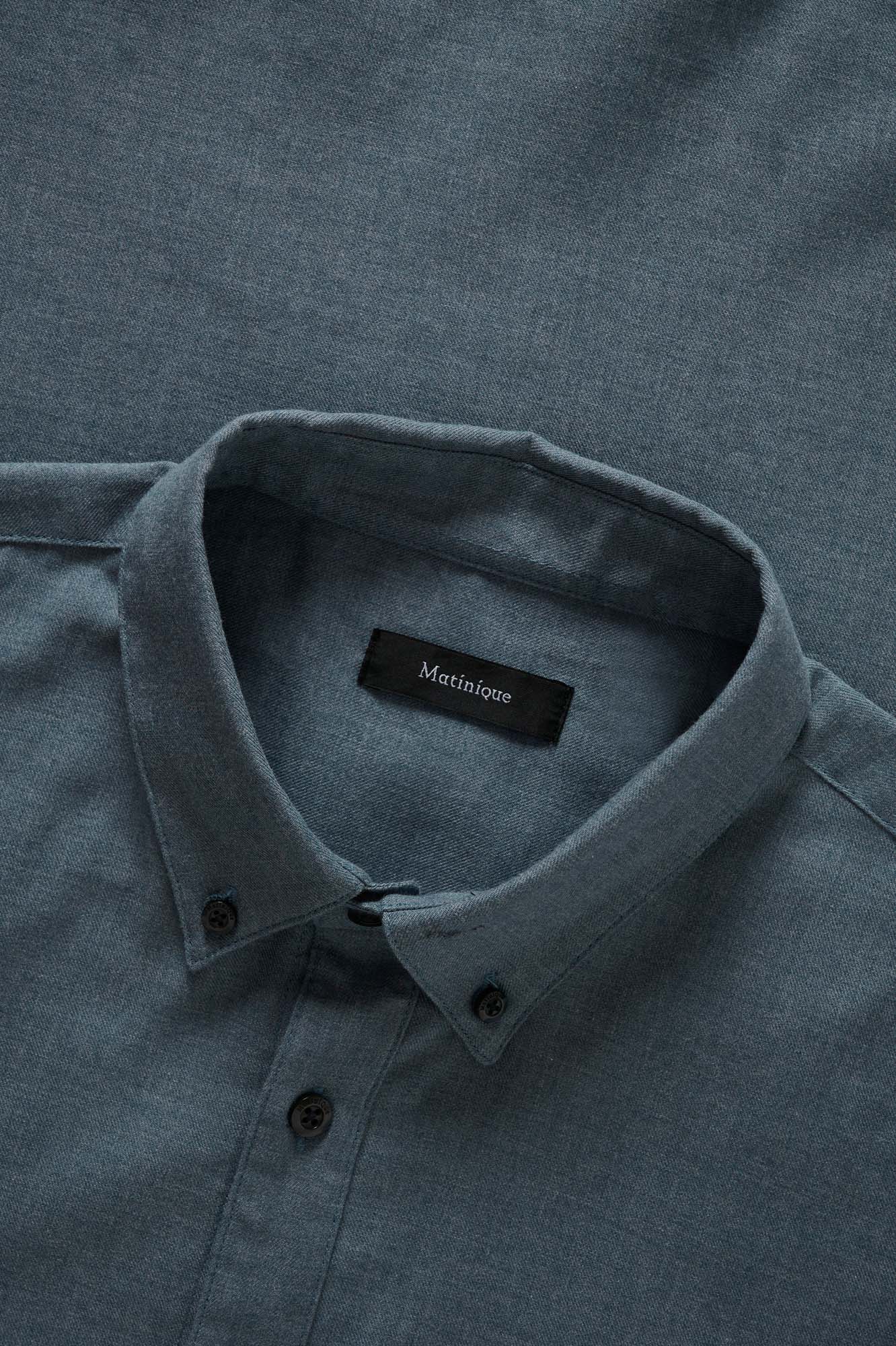 Matinique men's collar detail of the blue-gray long-sleeve shirt with black buttons, woven texture, and interior label
