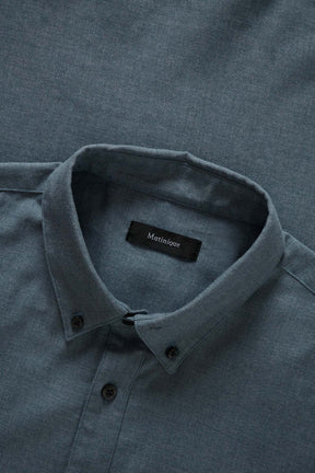 Matinique men's collar detail of the blue-gray long-sleeve shirt with black buttons, woven texture, and interior label