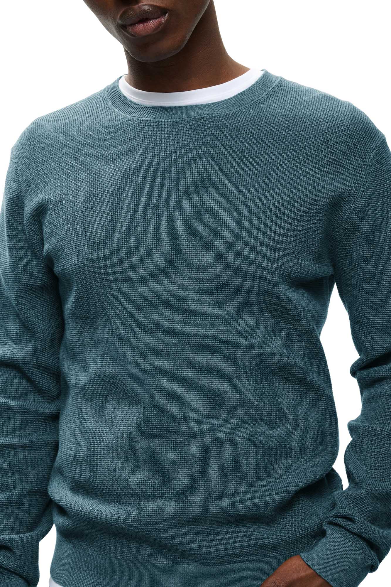 Men's close front view of teal textured crewneck knit long-sleeve knit sweater with ribbed collar by Matinique