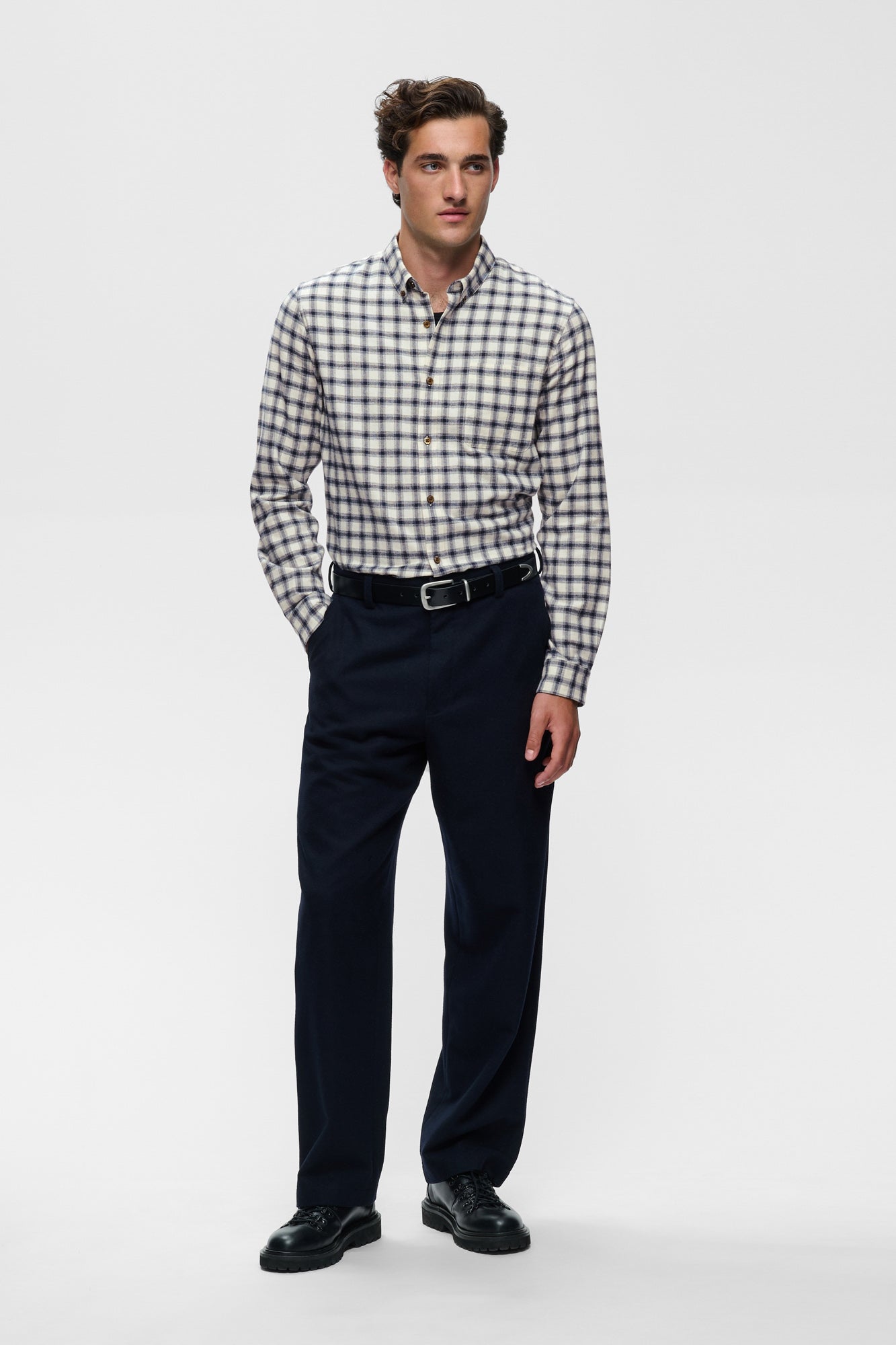 Men's full front model view of ivory and navy plaid long sleeve button-down shirt tucked in by Matinique