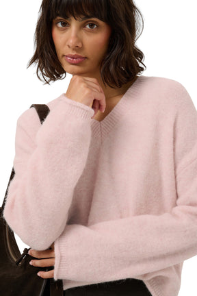Women's close front view of the pale pink fuzzy V-neck knit long-sleeve knit sweater showing ribbed collar and by Part Two