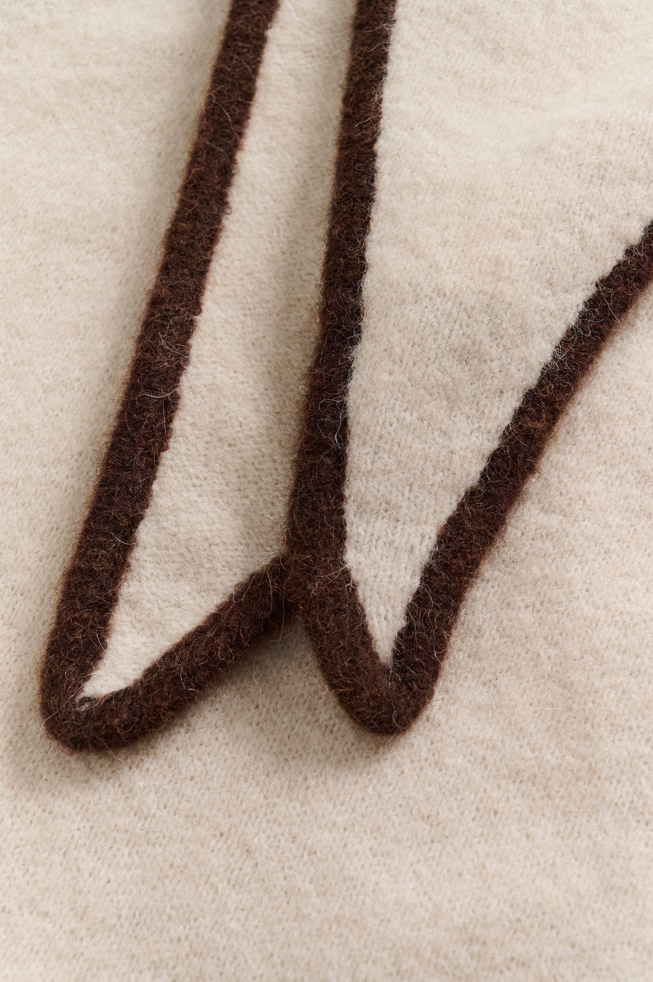 Part Two women's cream fuzzy knit scarf with dark brown border trim and pointed folded edges, close-up