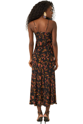 Vue de dos d’une robe midi noire à fines bretelles, imprimé botanique orange et rose pour femme par Lez a Lez
