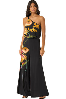 Vue de face d’un pantalon noir à jambe large avec imprimé floral multicolore sur une jambe pour femme par Lez a Lez