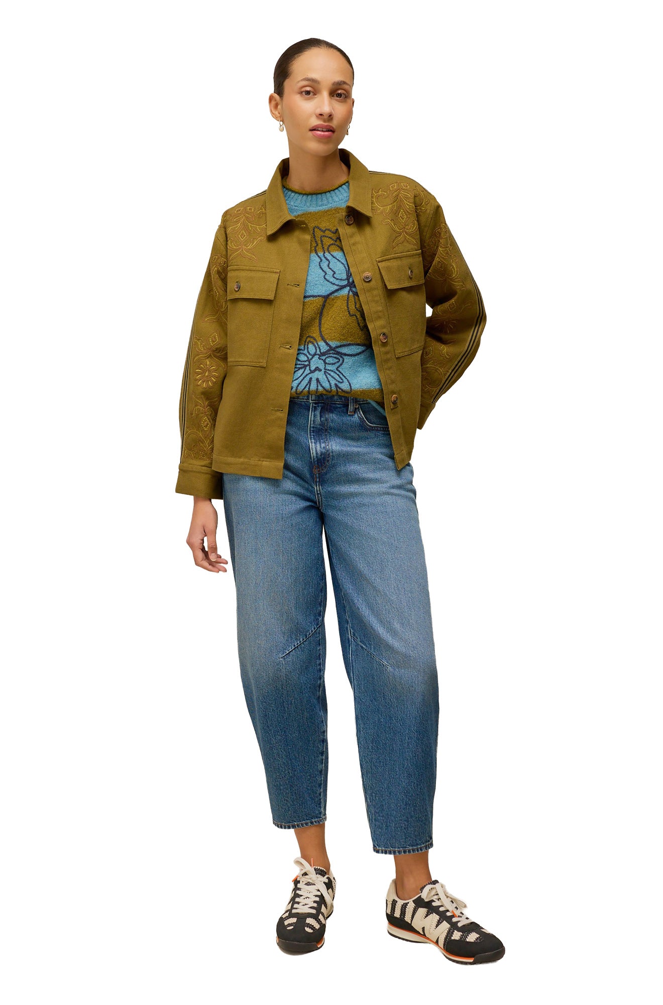 White Stuff women's styled front view of blue and olive striped long-sleeve knit sweater worn under a khaki jacket