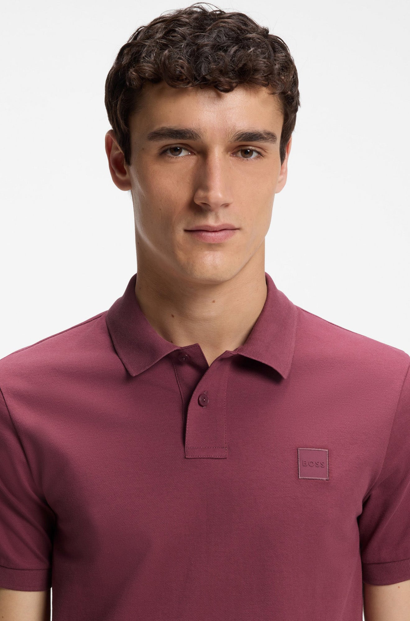 HUGO BOSS men's close front view of burgundy short-sleeve polo collar, button placket, piqué texture, and tonal BOSS patch