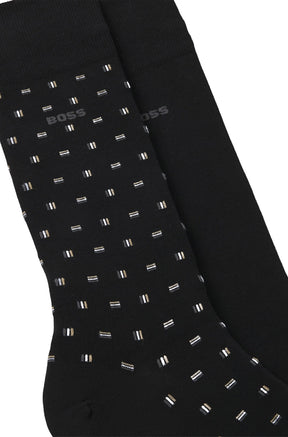 HUGO BOSS men's black dress socks showing small dash pattern, solid sock, knit texture, and gray BOSS logo, close-up