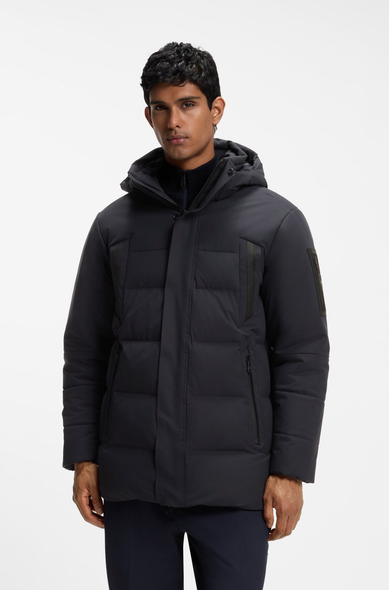 HUGO BOSS men's dark navy hooded winter jacket with padded panels and zip pockets, front model view