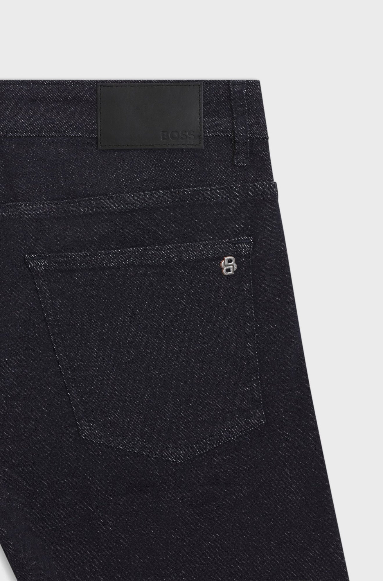 HUGO BOSS men's back waistband detail of dark black straight-leg jeans with BOSS patch, back pocket and small logo hardware