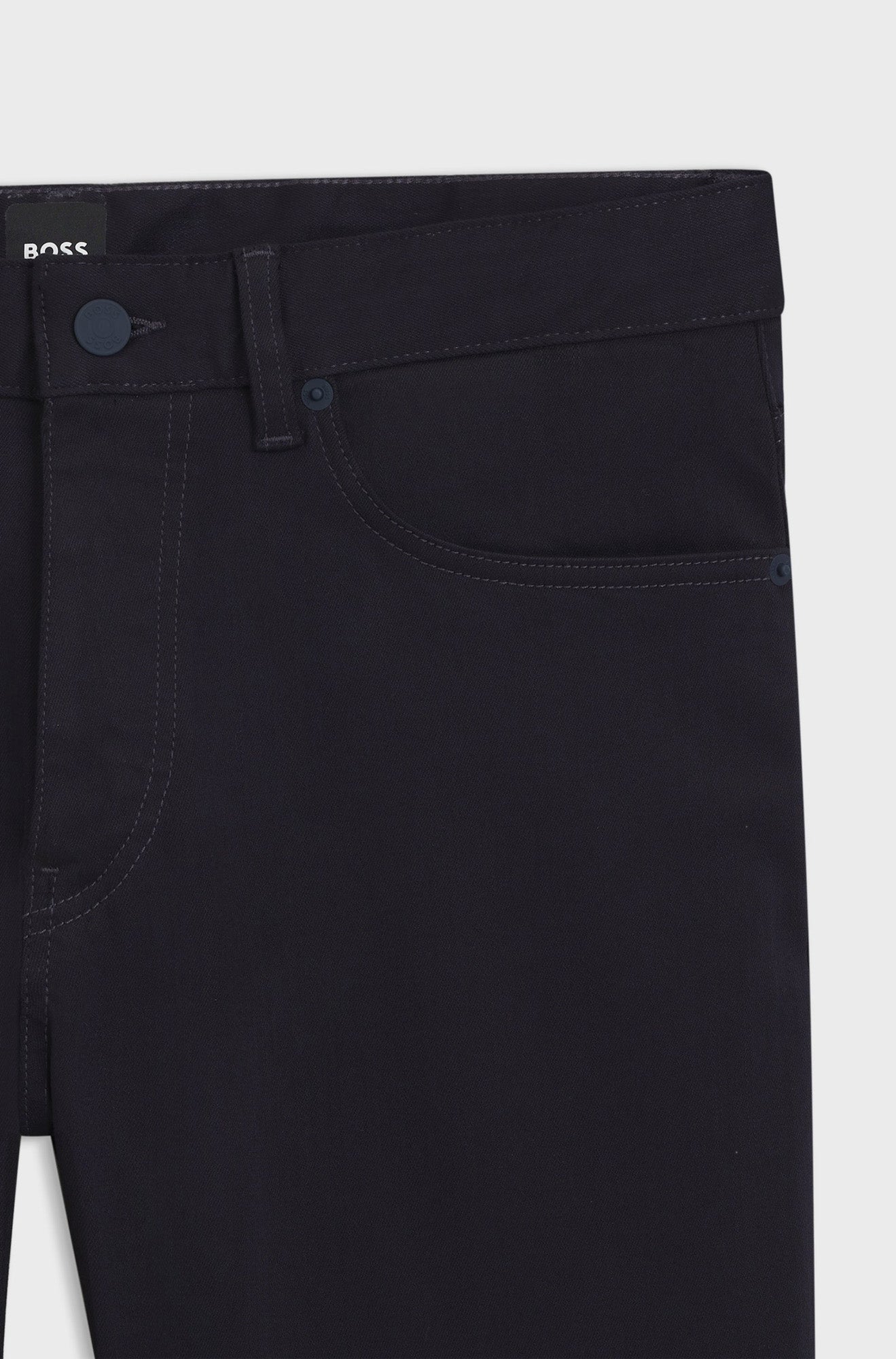 HUGO BOSS men's black jeans front waistband with button closure, belt loops, rivets, and pocket, close-up