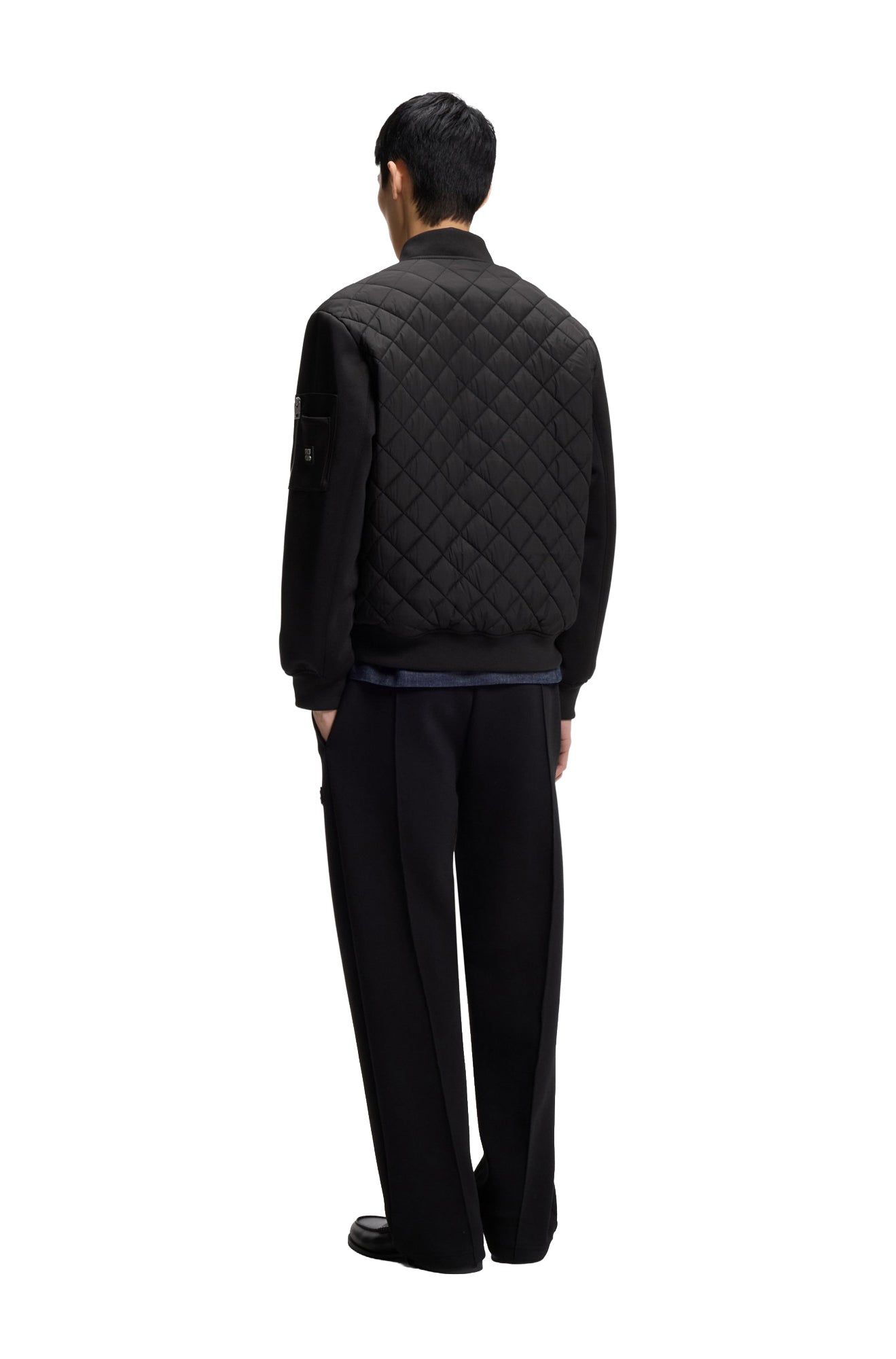 Vue arrière de la veste noir matelassée avec surpiqûres losanges et taille côtelée pour homme par HUGO BOSS
