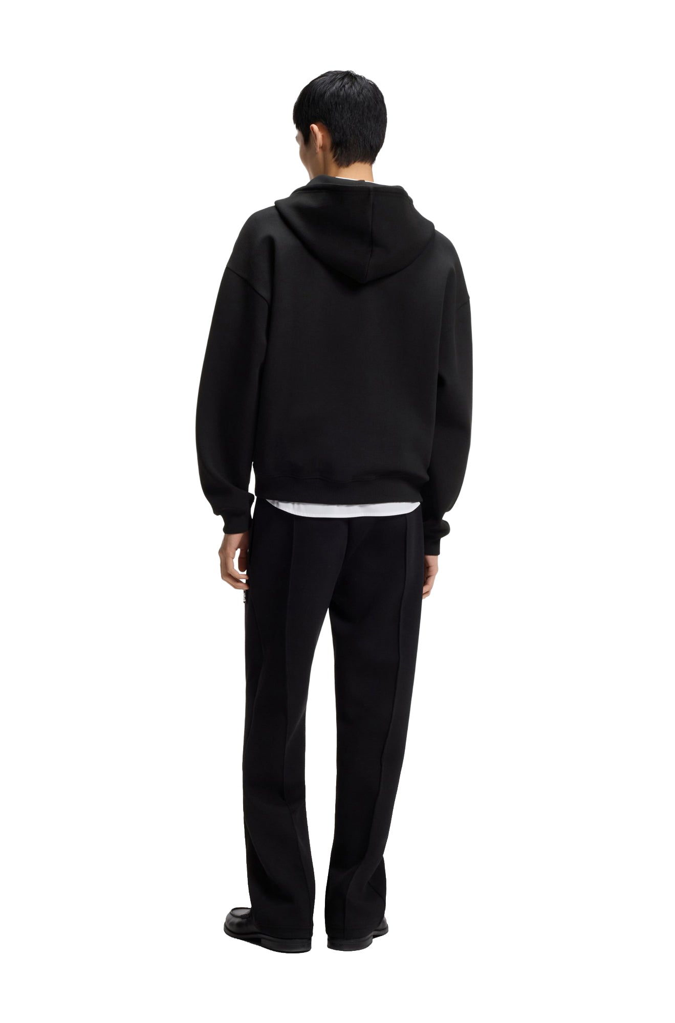HUGO BOSS men's black half-zip sweatshirt on model, showing the plain back, hood, long sleeves and ribbed hem, back view