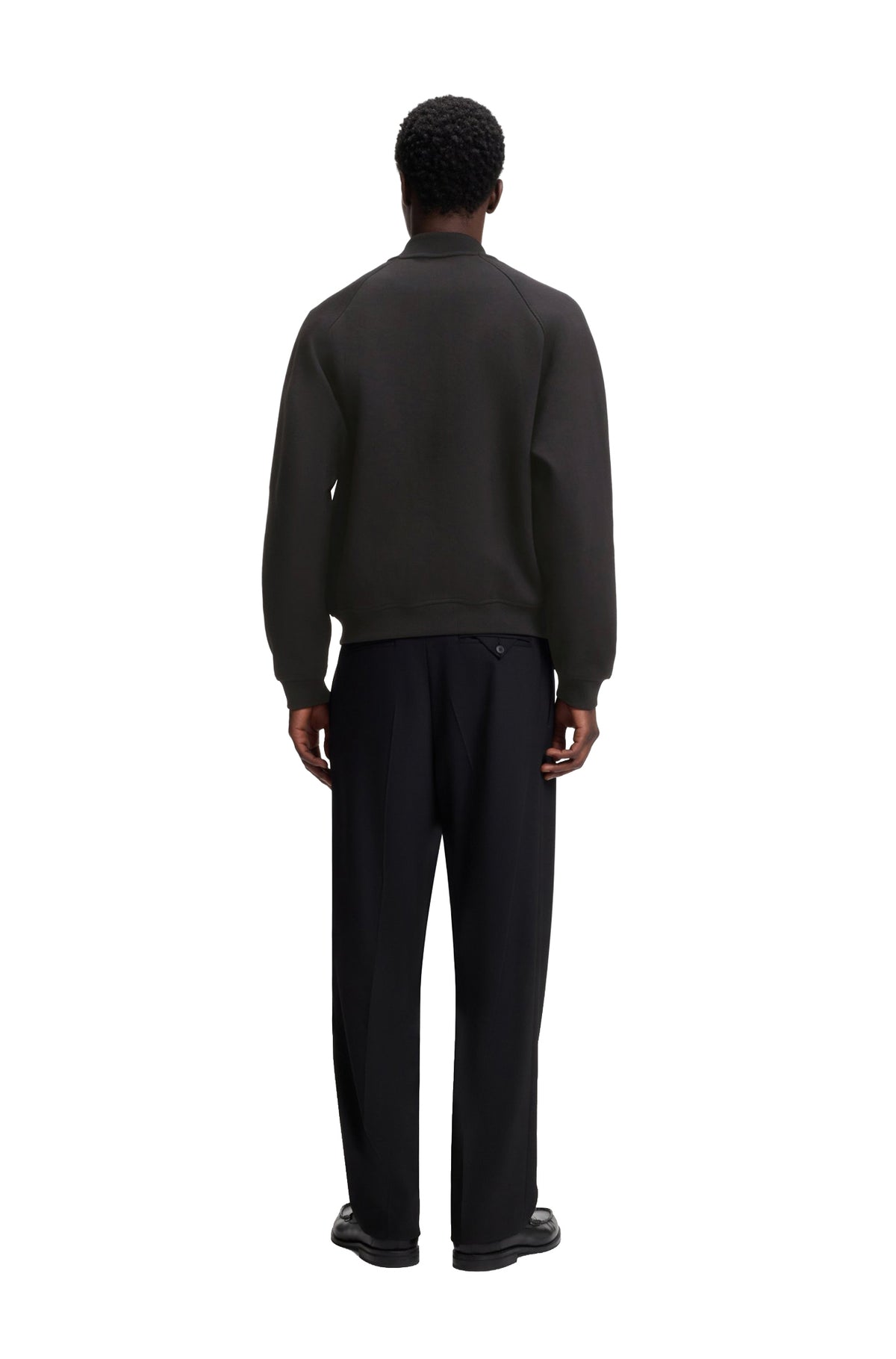 HUGO BOSS men's black bomber jacket on model with raglan sleeve seams and ribbed hem and cuffs shown from the back