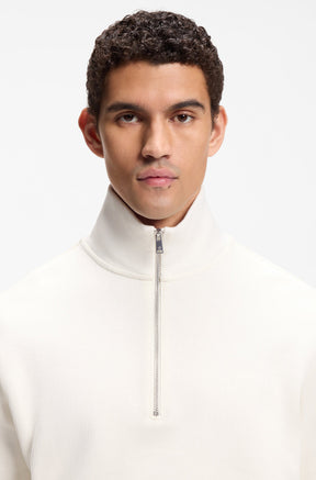 HUGO BOSS men's cream stand collar and silver zipper on a textured quarter-zip sweatshirt, close-up