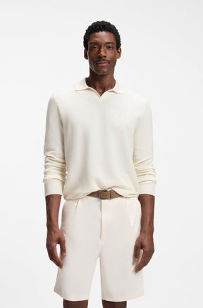HUGO BOSS men's cream long sleeve knit polo sweater on model, front view with open collar and ribbed cuffs