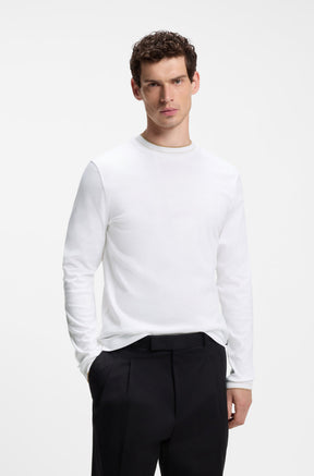 HUGO BOSS men's white long sleeve crewneck T-Shirt on model, with beige trim at neck and sleeve openings, front view