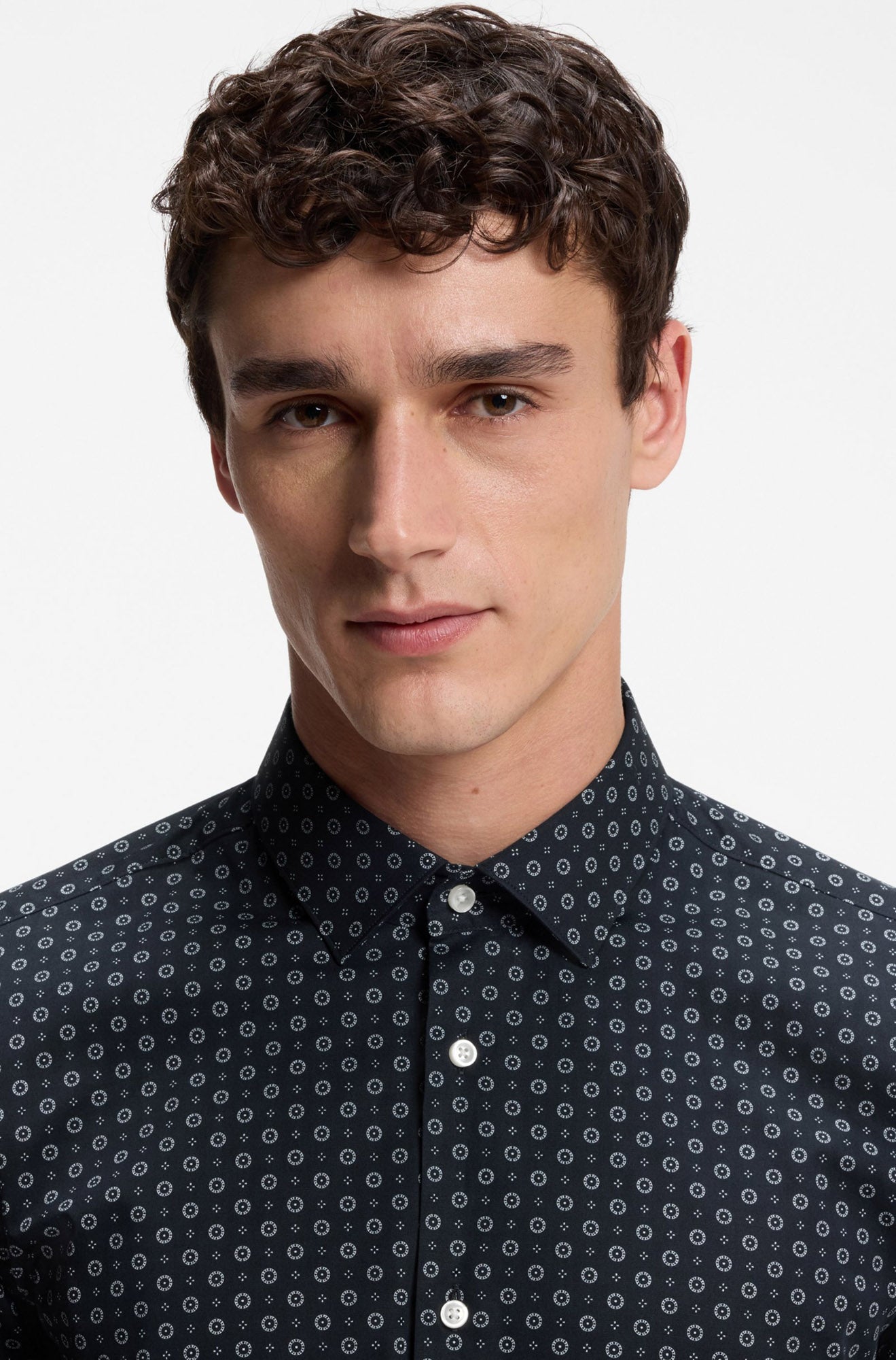 Close-up of men's navy geometric-print long-sleeve dress shirt collar and white button placket on model by HUGO BOSS