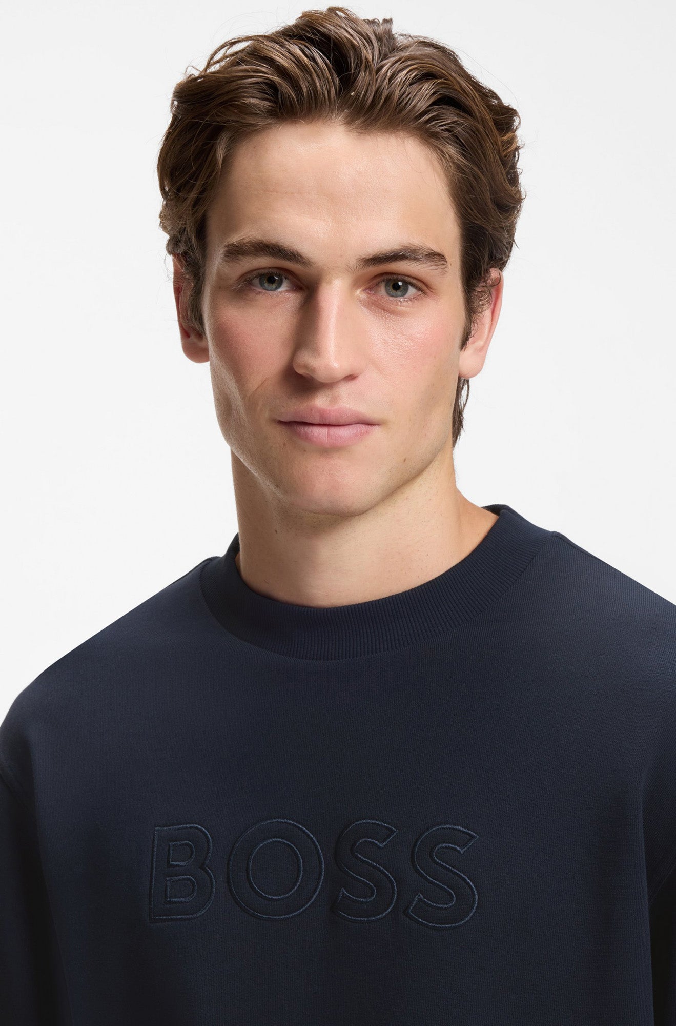 HUGO BOSS men's close front detail of a navy crewneck sweatshirt with ribbed collar and tonal BOSS chest logo