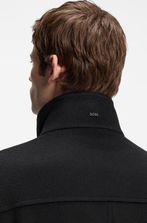 Men's back close-up of black winter coat collar with small metal BOSS logo and tonal stitching by HUGO BOSS