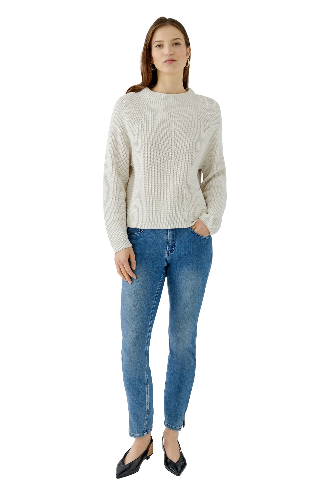 Women's full-length front model view of cream rib-knit crewneck long-sleeve knit sweater with one front patch pocket by Oui