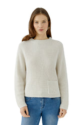 Women's front waist-up model view of cream rib-knit crewneck long-sleeve knit sweater with single patch pocket by Oui
