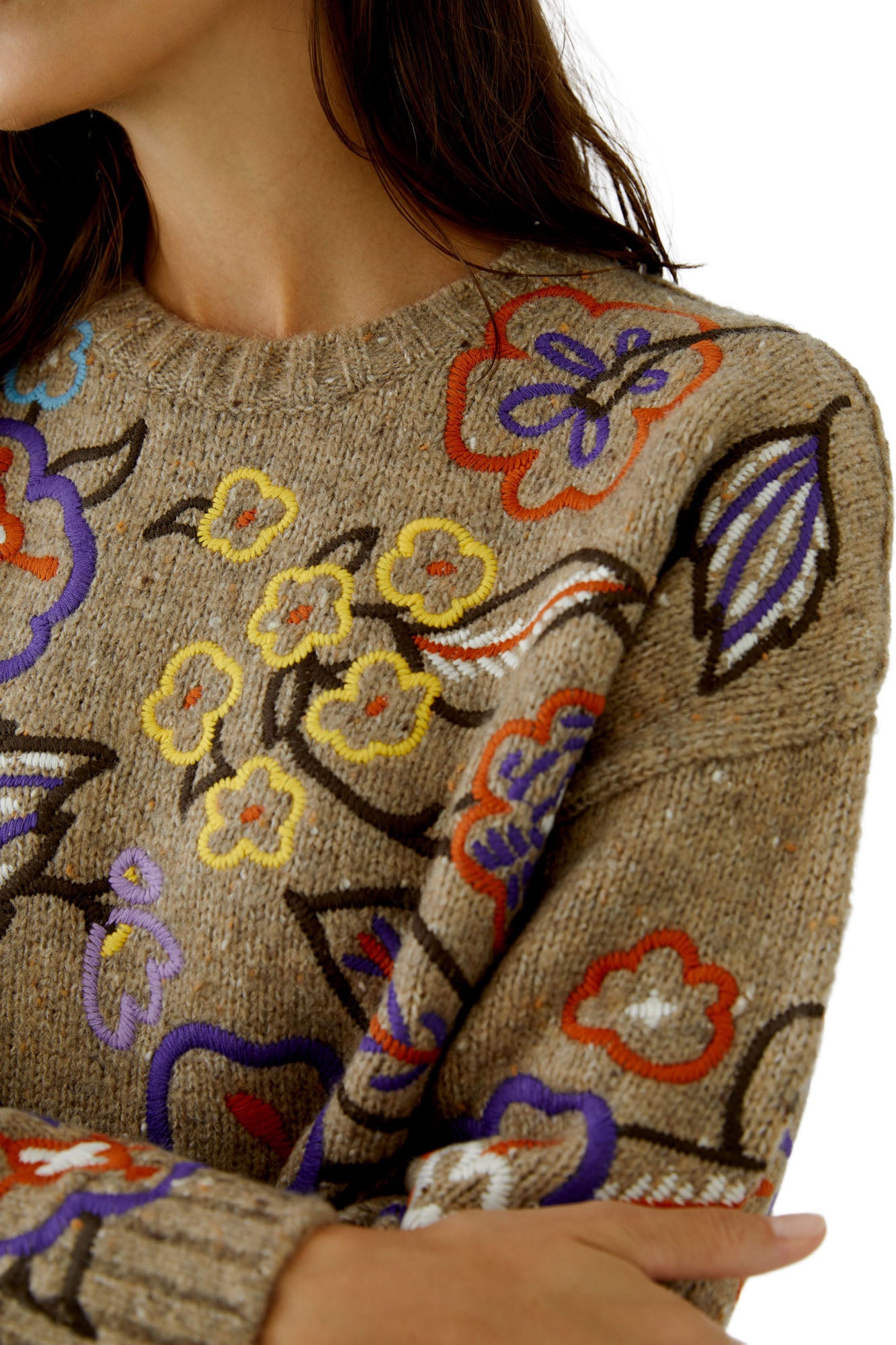 Close-up of women's oatmeal beige knit long-sleeve knit sweater showing ribbed crewneck and raised floral embroidery by Oui
