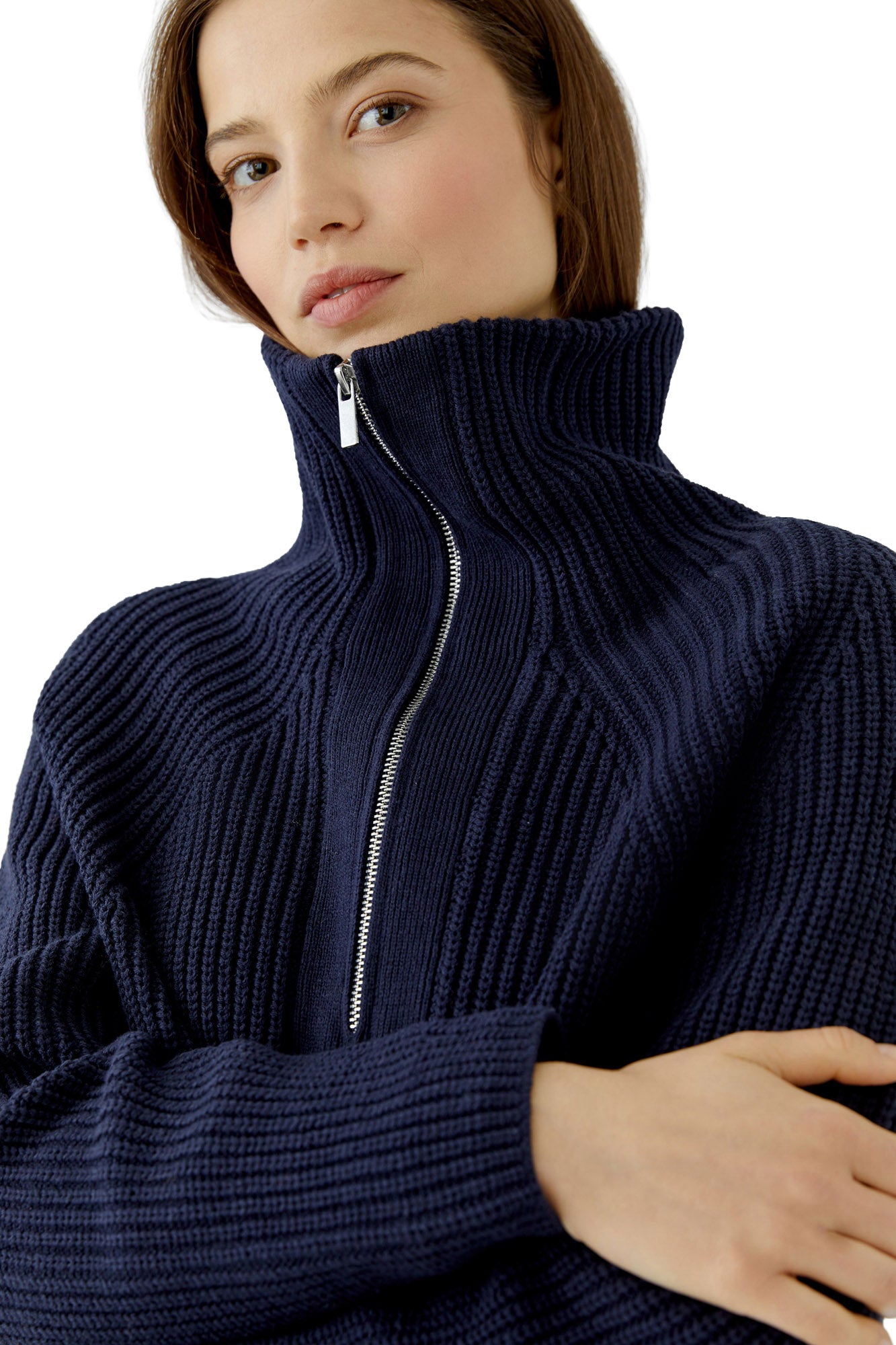 Women's close detail of navy ribbed knit sweater with raised zip collar and silver zipper teeth by Oui