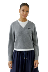 Oui women's front waist-up model view of gray V-neck knit long-sleeve knit sweater with black chest text and ribbed hem